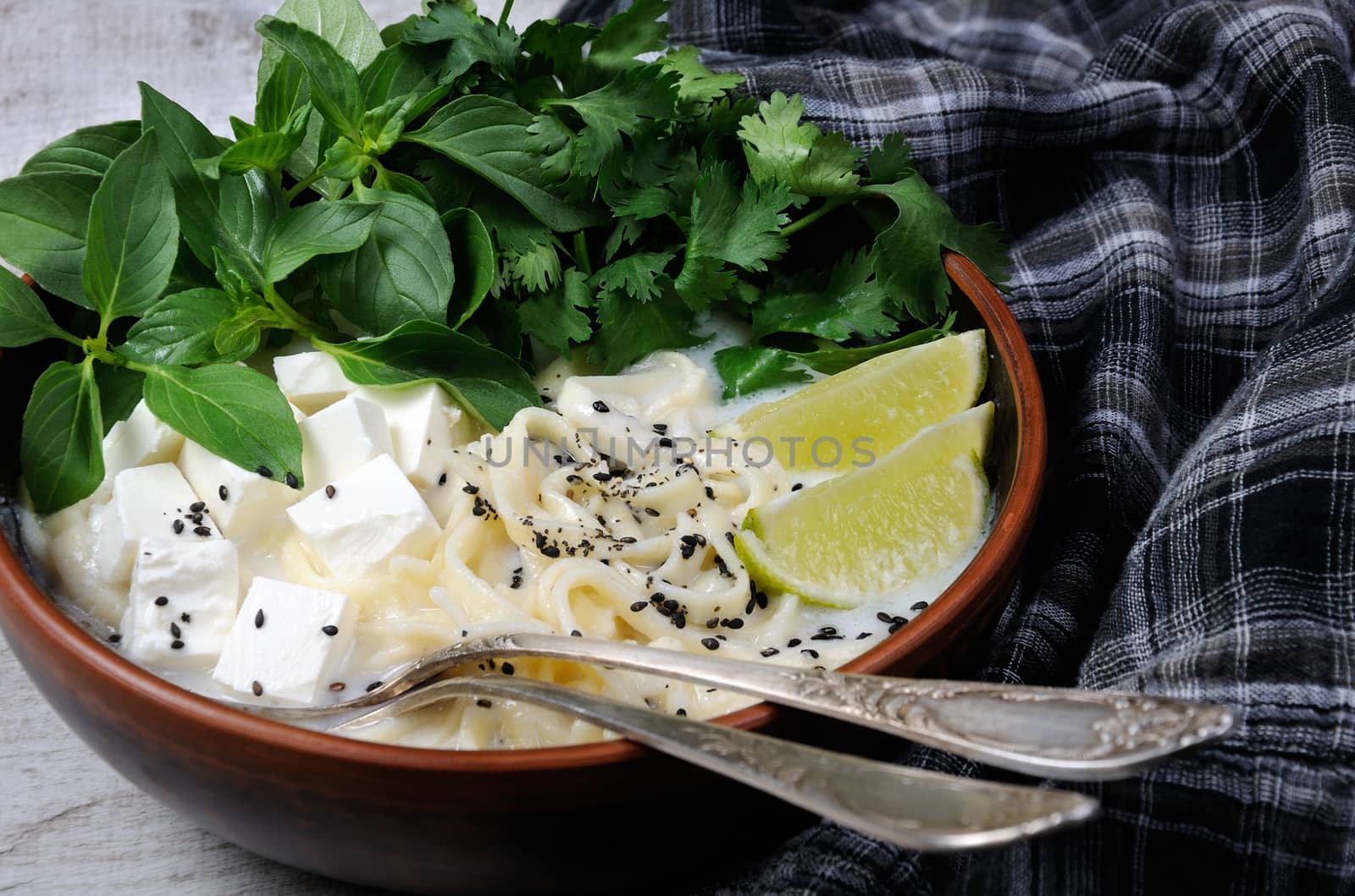 Rice soup with noodles and tofu flavored with lemon grass (basil), cilantro, sesame.