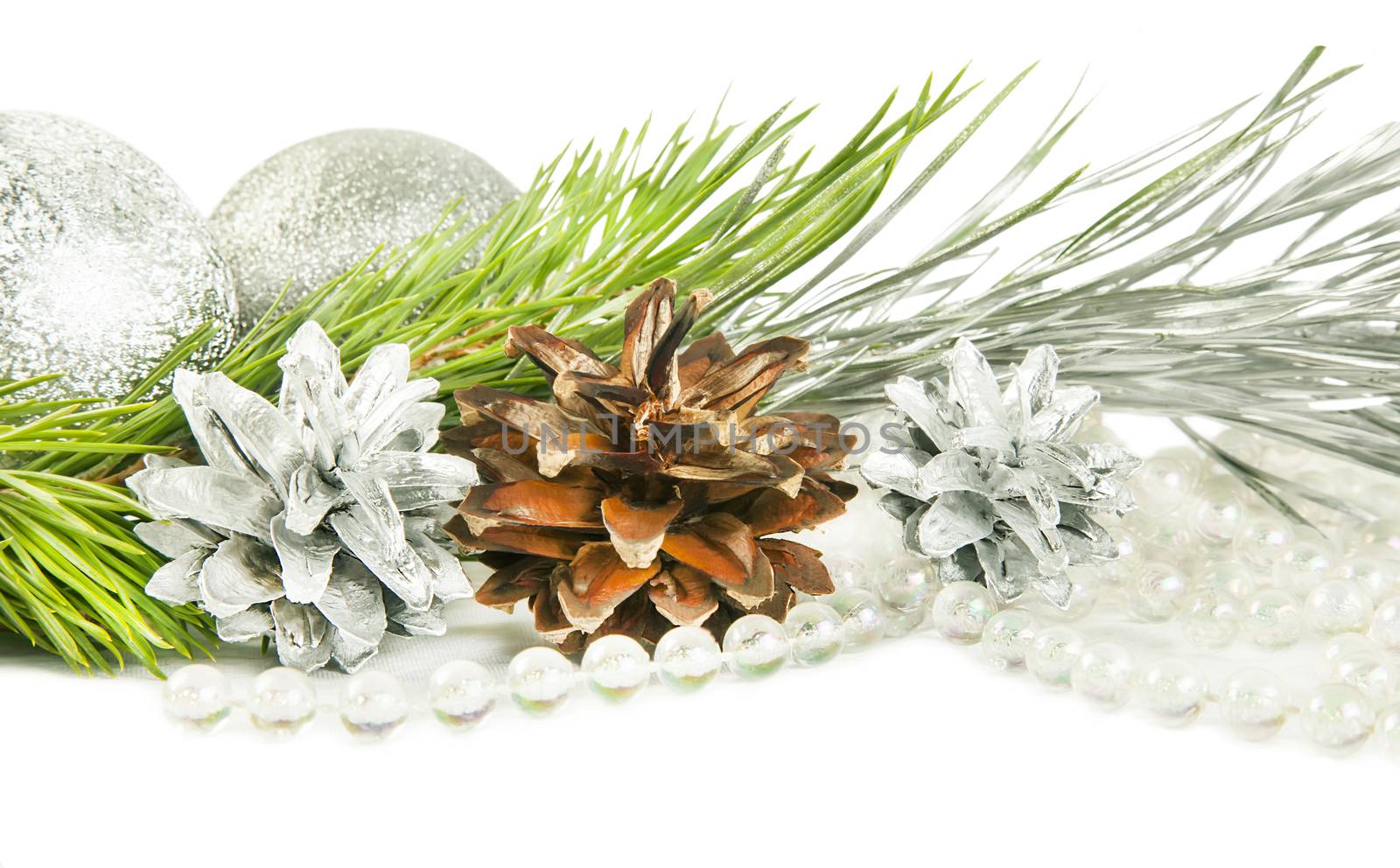 Fir tree branch and cones with silver ball isolated on white backround