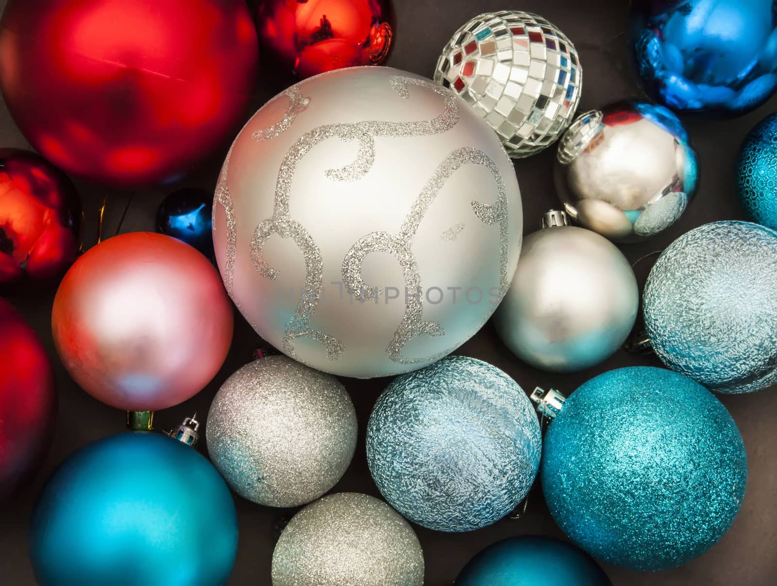 Silver, red and blue new year decorations on dark background close up