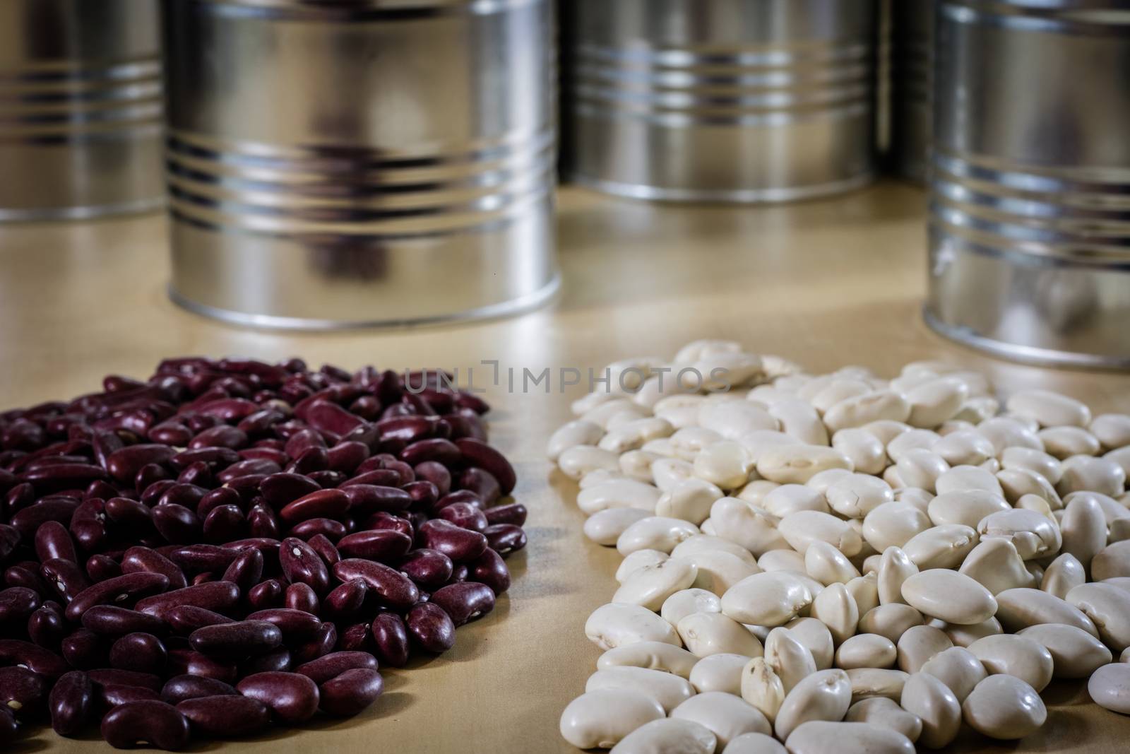 Delicious beans in a metal jar on a wooden kitchen table. Black background.