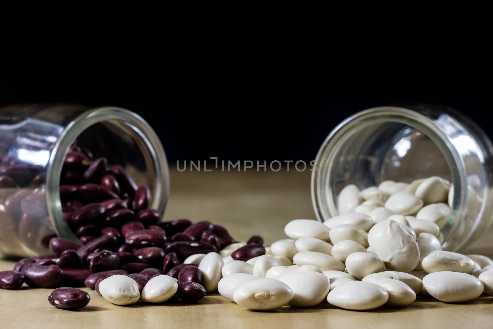 Delicious bean in a glass jar on a wooden kitchen table. by wytrazek