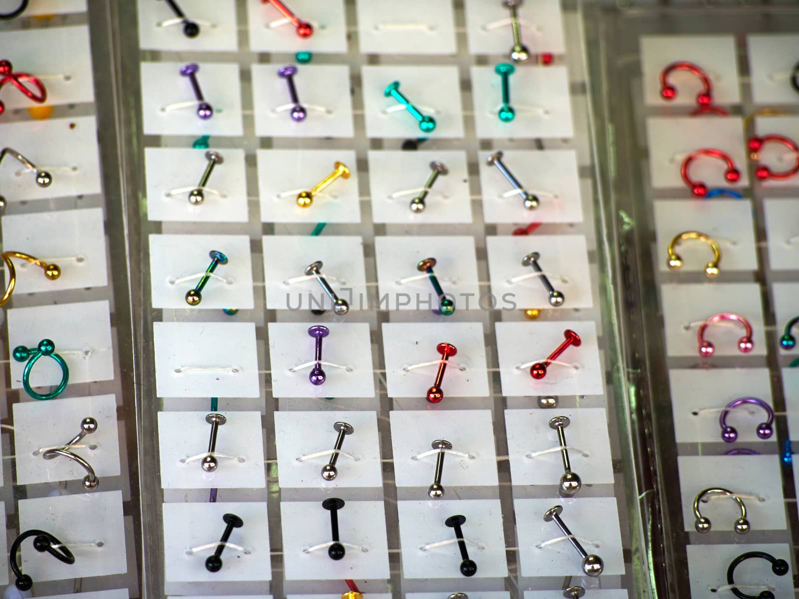 Colorful jewelry for ear, nose and body piercing in a shop display