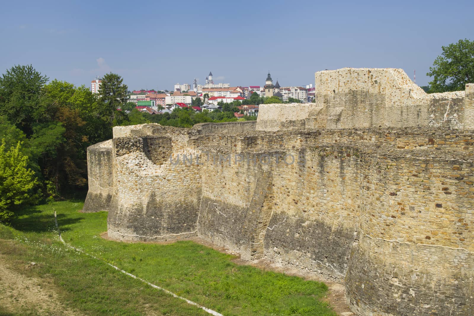 Medieval ruins of Suceava fortress and city behind