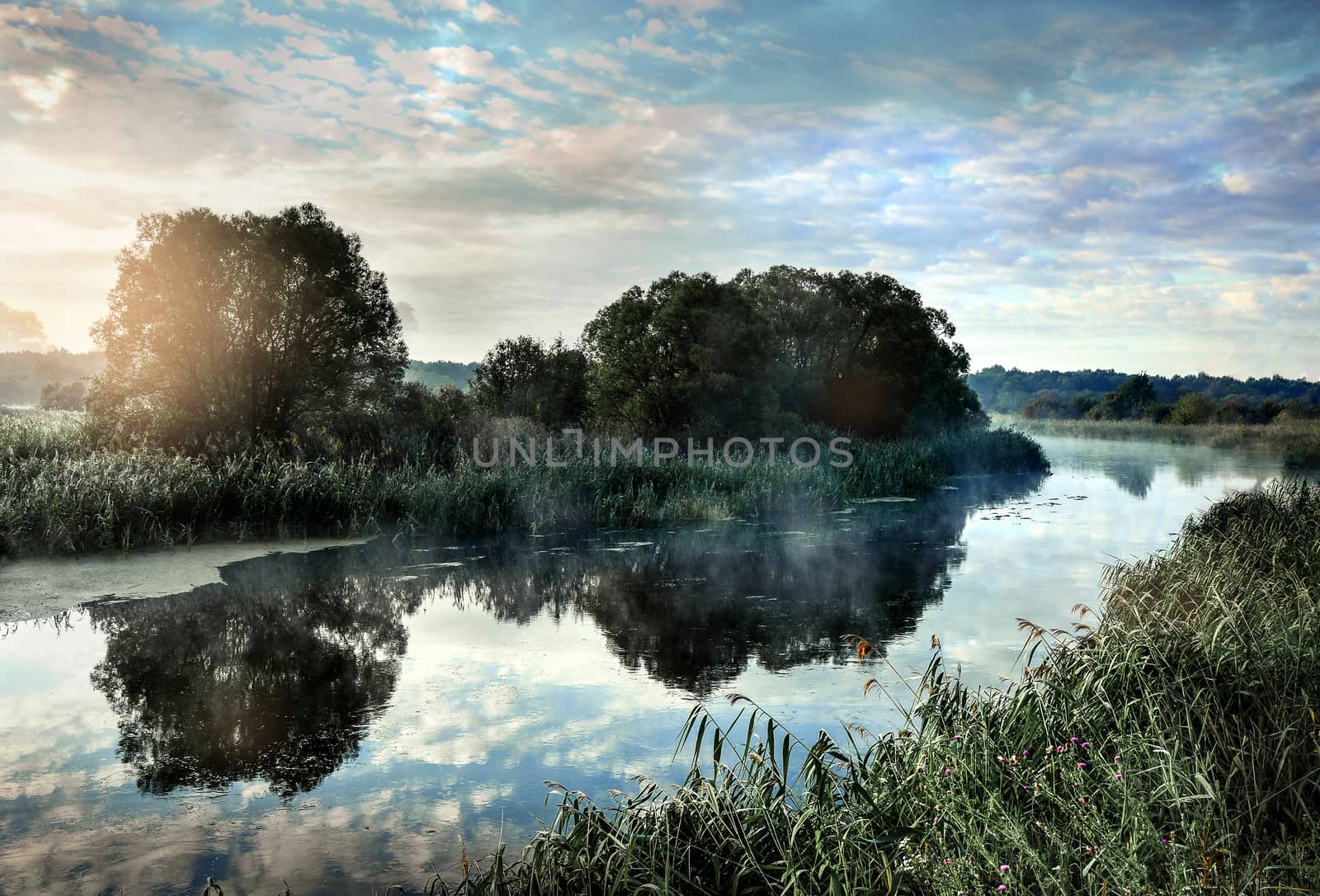 Photo with a sunny summer sunrise over the river.