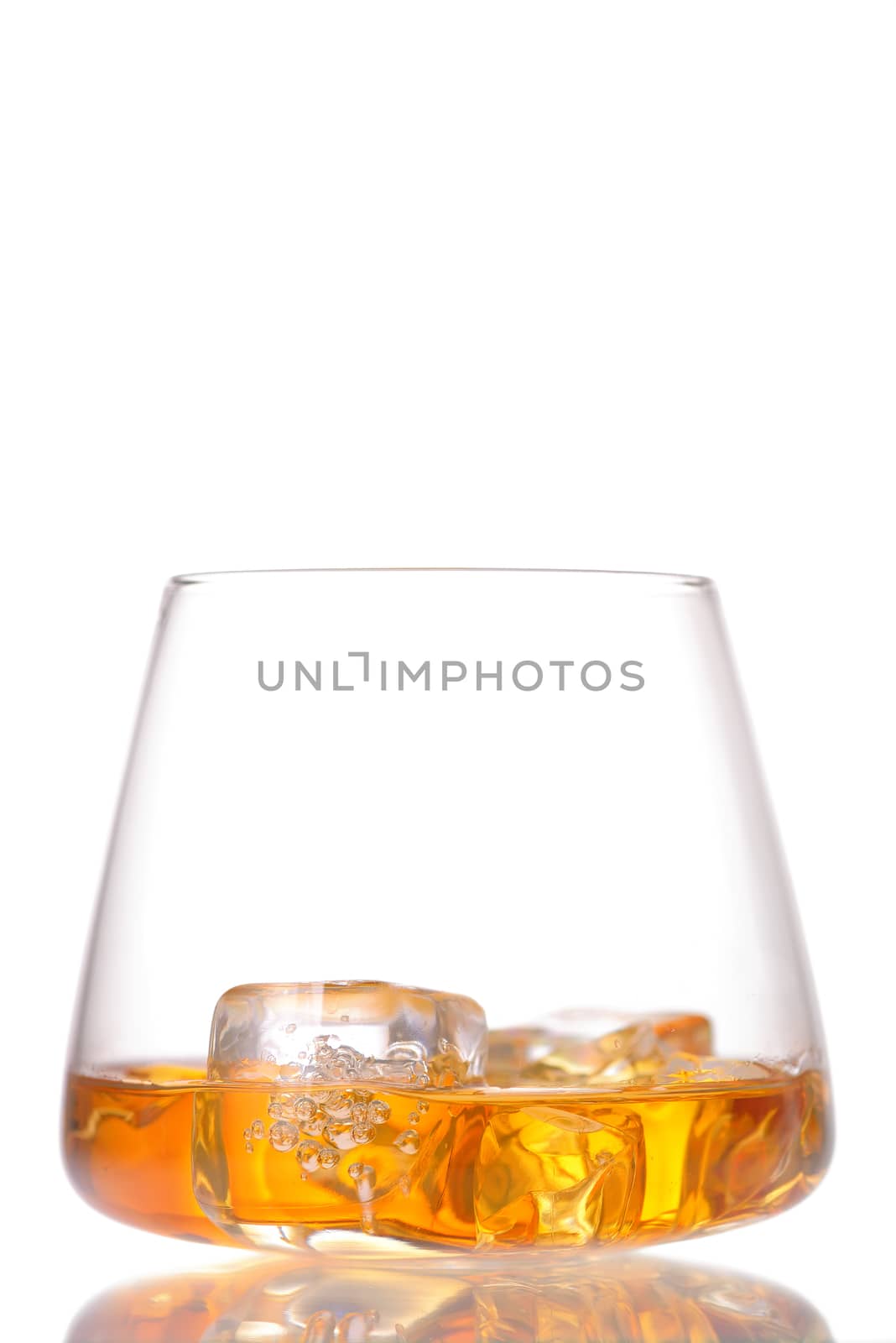 Glass of scotch whiskey and ice isolated on white