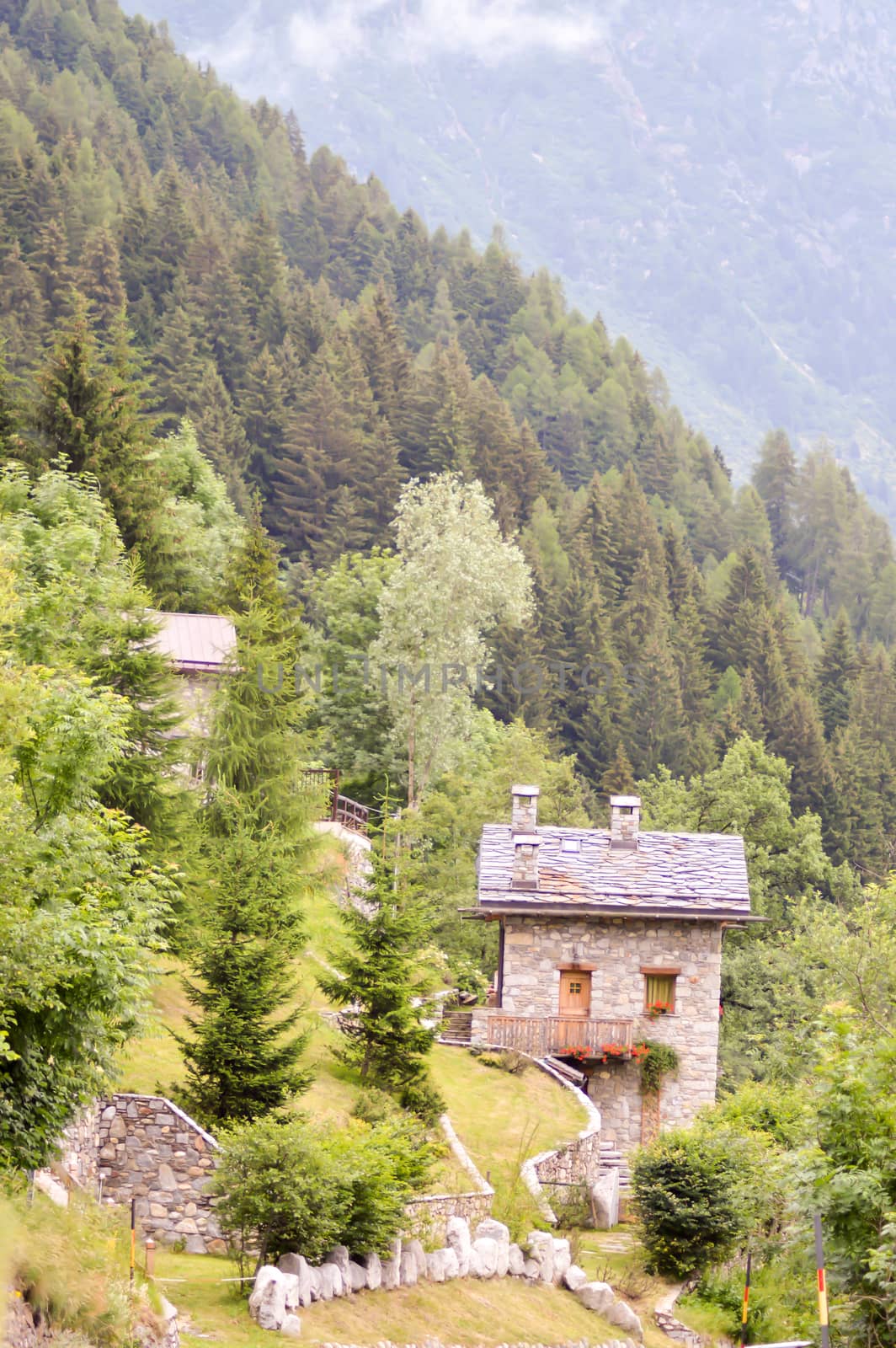 Traditional stone chalet in a dolomite pass in Italy