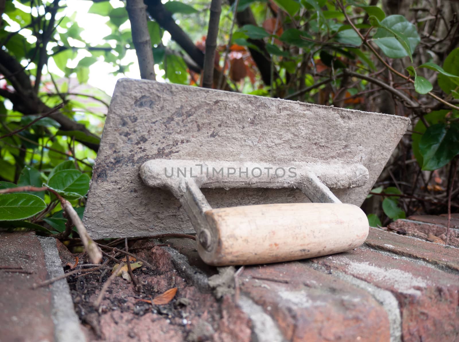 a plastering tool flat trowel resting on a wall ; UK
