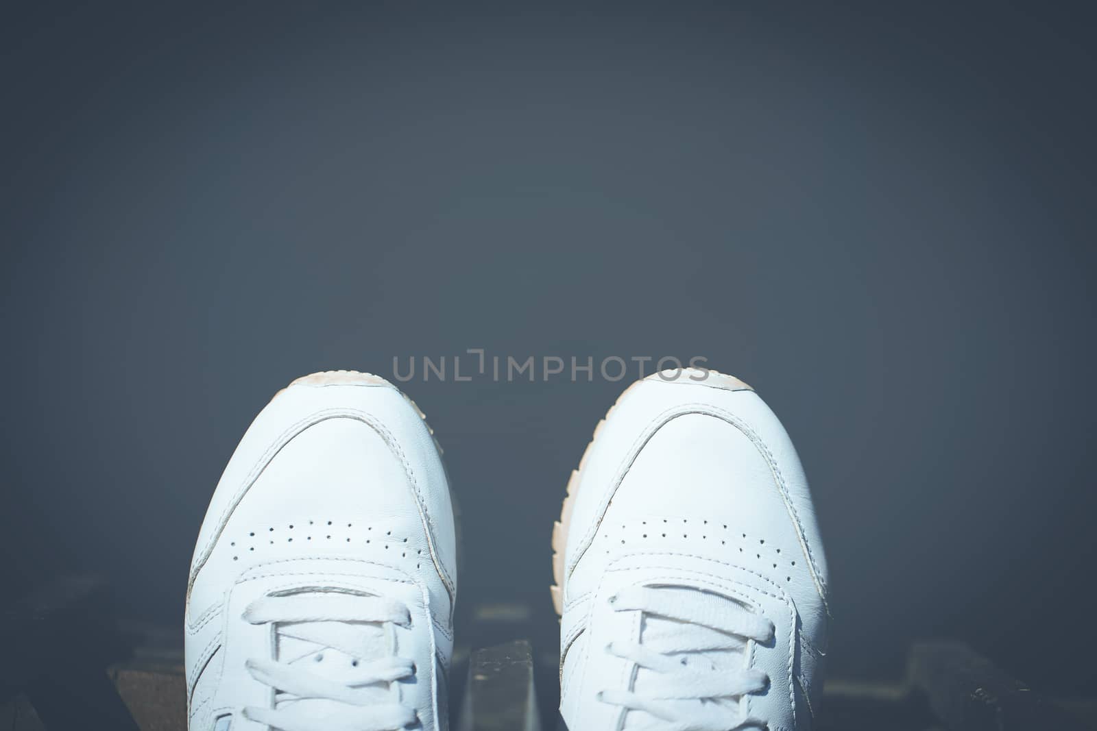 Female feet on the edge of the pier. by boys1983@mail.ru