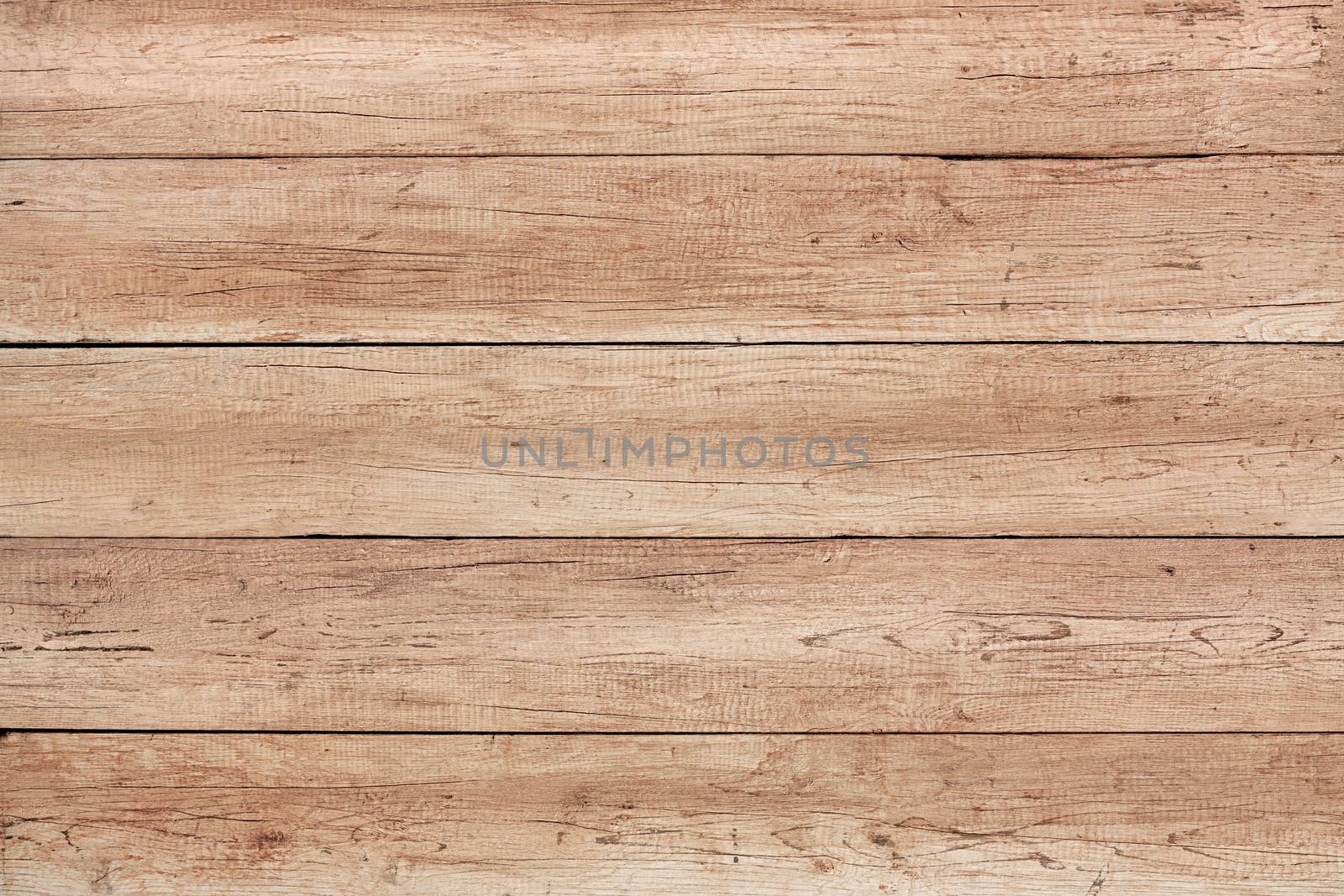 Old weathered wood surface with long boards lined up. Wooden planks on a wall or floor with grain and texture. Light neutral tones.