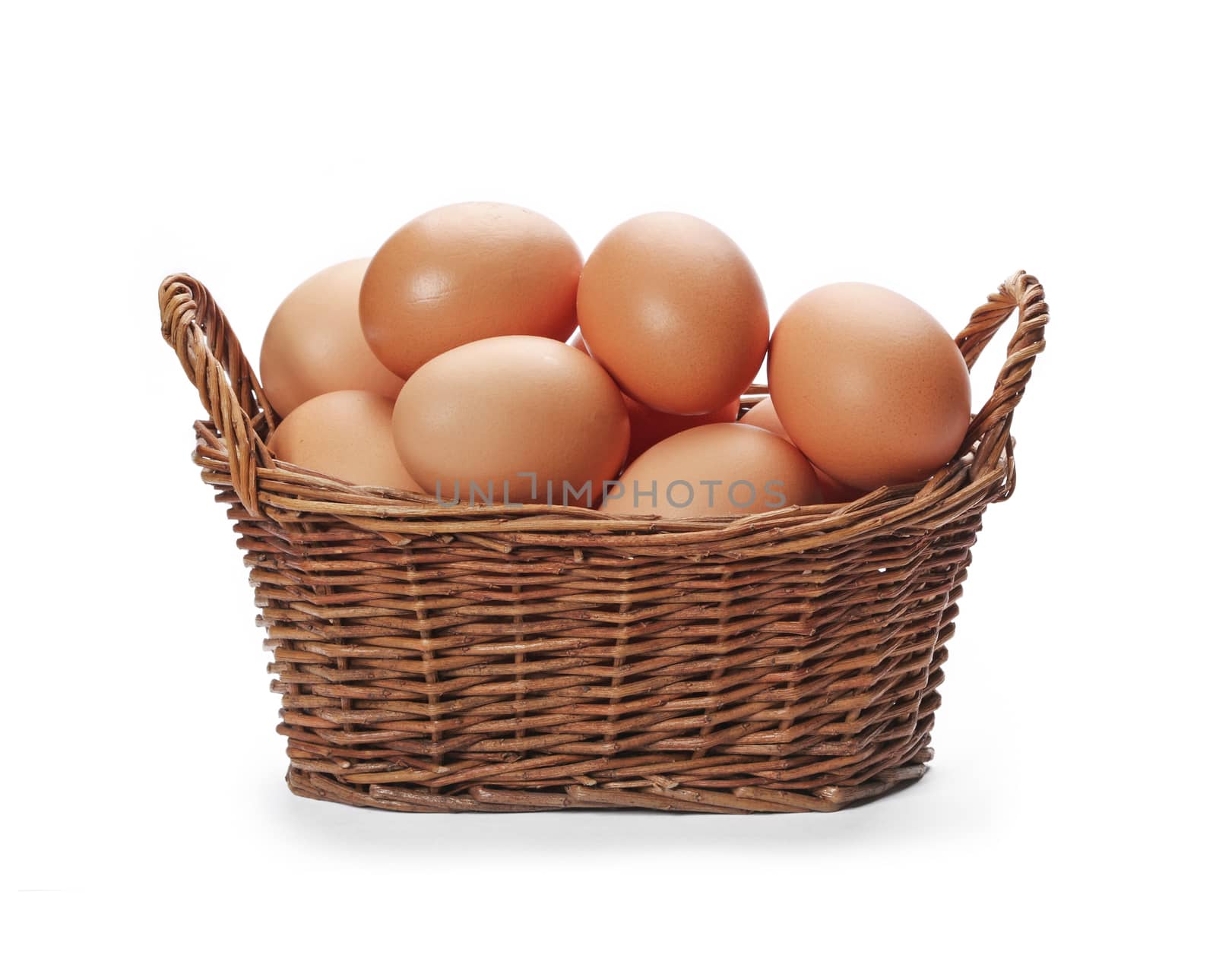 Brown eggs in the basket isolated on white background.
