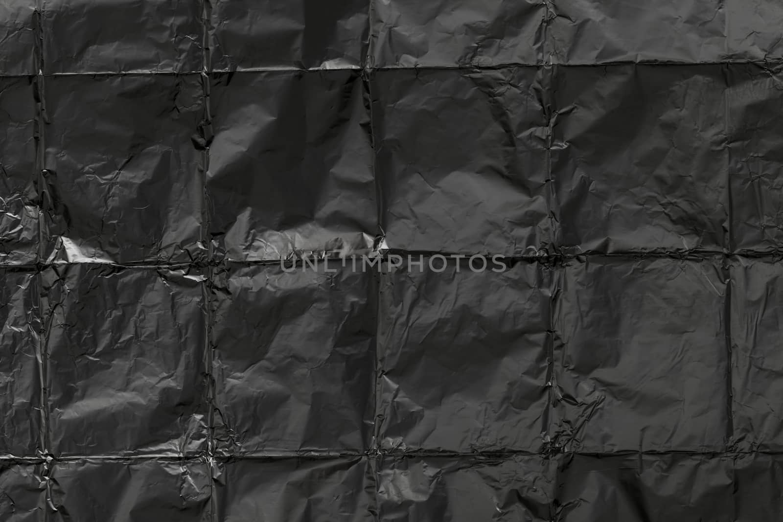 Creased aluminum foil background texture, black texture