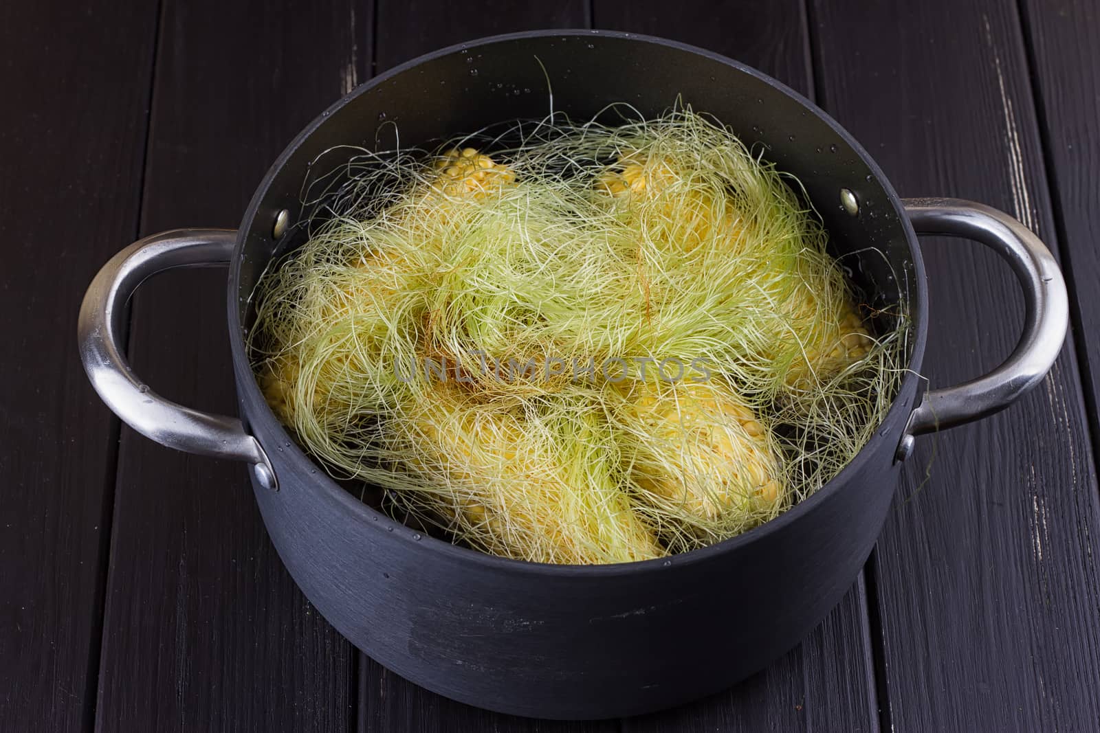 Corn on the cob boiling in a pot