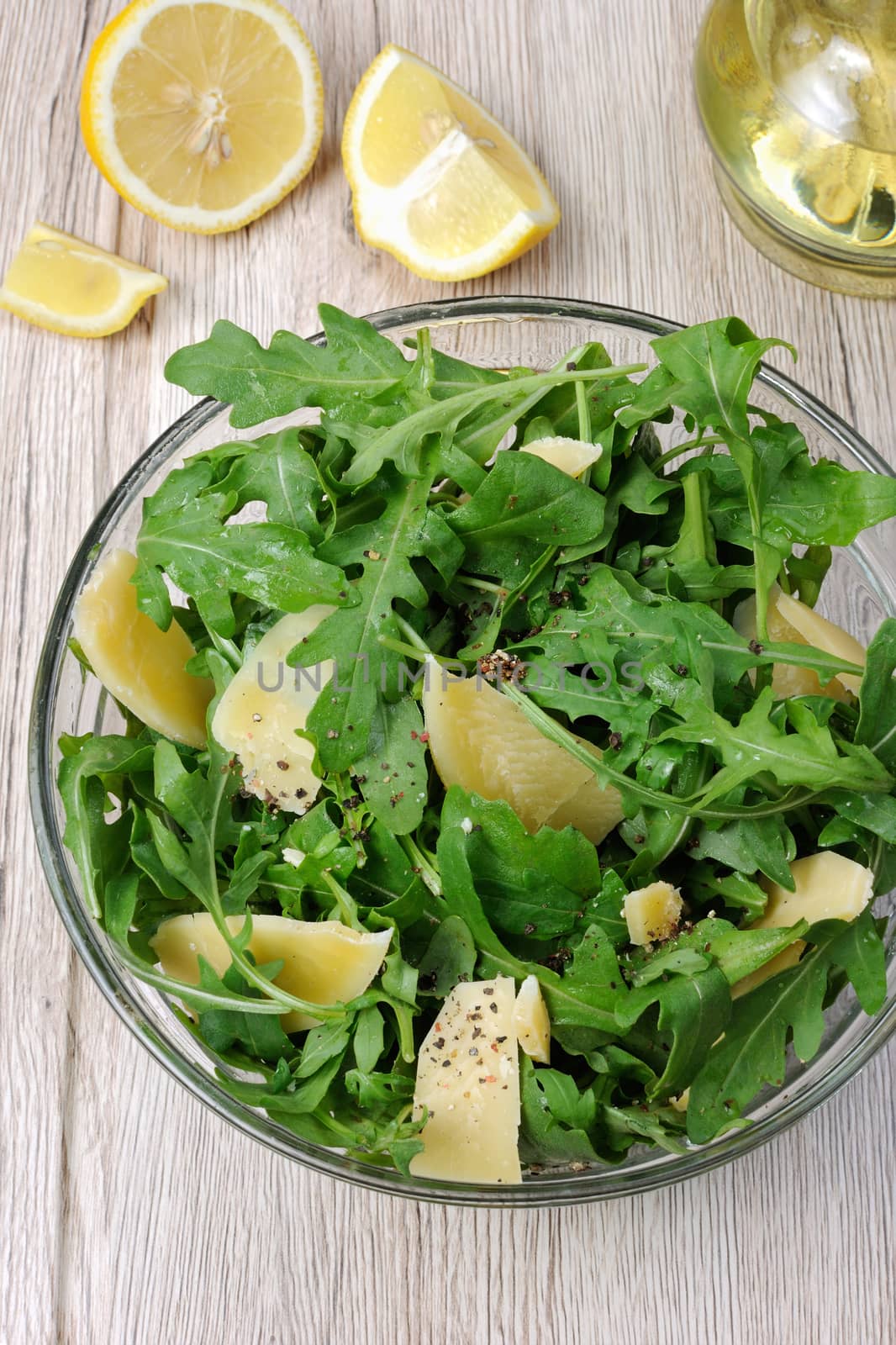 Arugula (rocket) salad dressed with balsamic soy sauce , Parmesan shavings and freshly ground black pepper, sesame.  