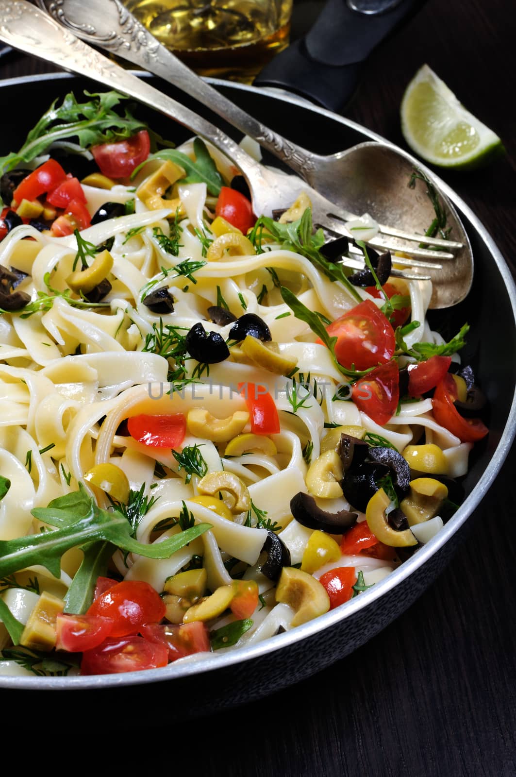 Pasta with crushed olives and cherry tomatoes, arugula. 