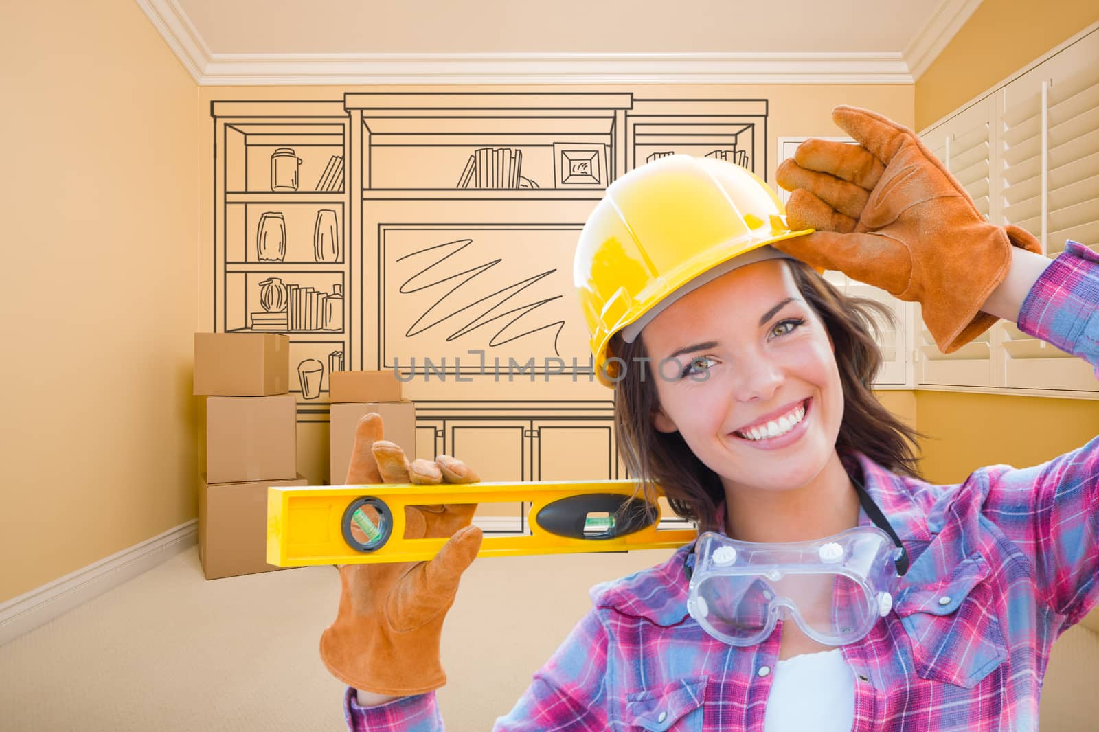 Female Construction Worker Holding Level In Front of Custom Built In Entertainment Unit Drawing in Empty Room.