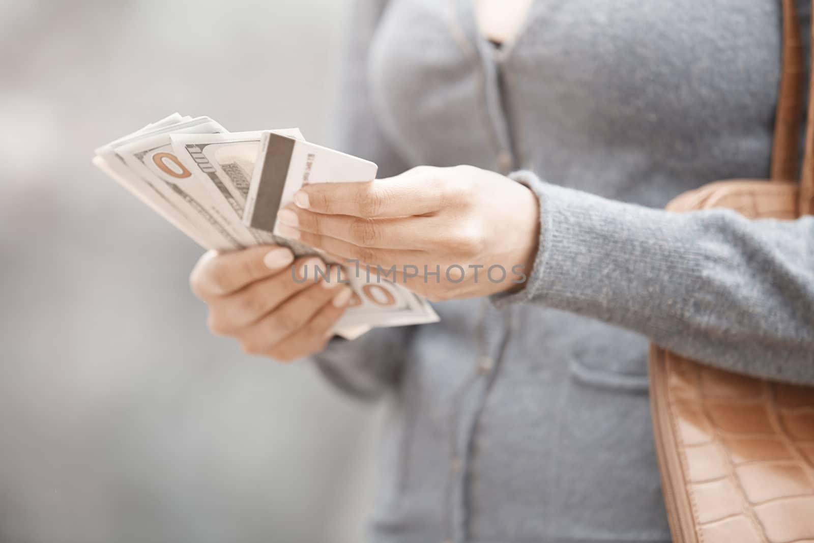 Woman holding cash money and credit card by Novic