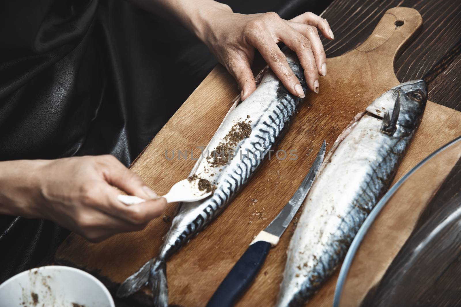 Woman preparing mackerel fish