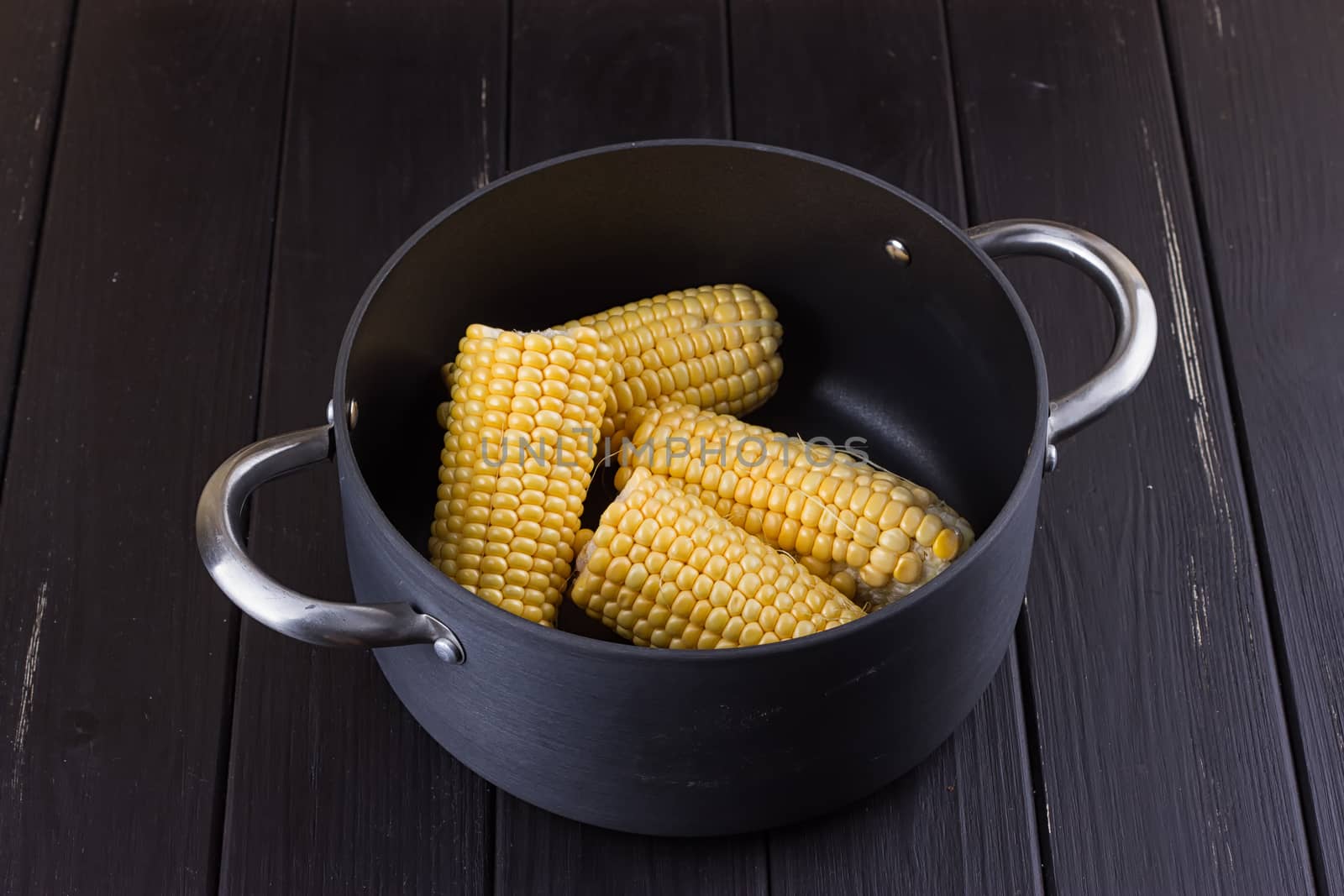 yellow gold colorful sweet maize corn boiling cooking in a large aluminum pot with charcoal outdoor on a pathway i