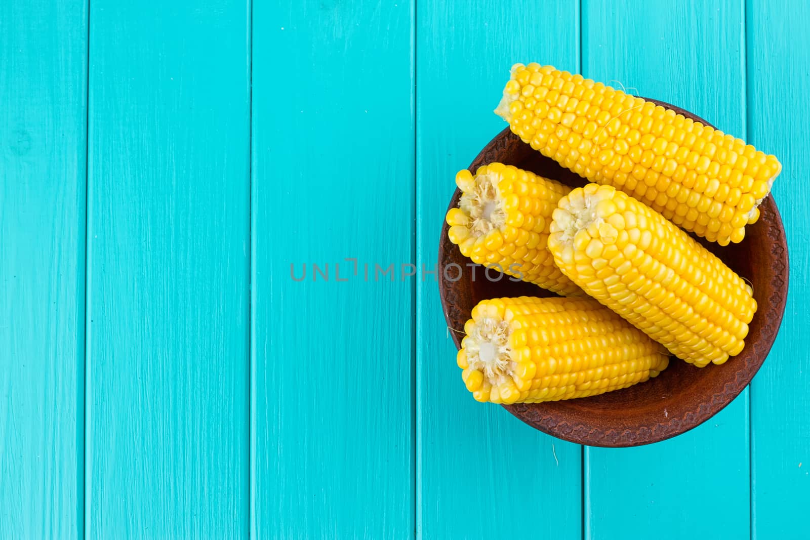 Boiled corn on a blue background by victosha