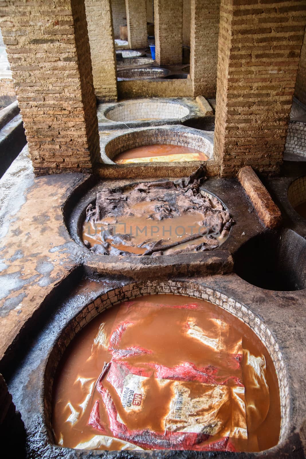 Tannery in the middle of souk in Fez, Morocco. Traditional leather tannery from the 11th century is now biggest tourits attraction in Fes.