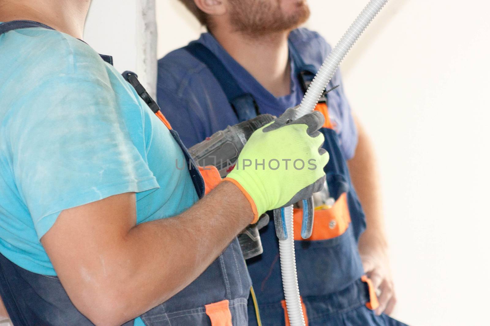 Construction concept. An electrician holds a wire in the hands of the work planning stage. Horizontal sheet orientation