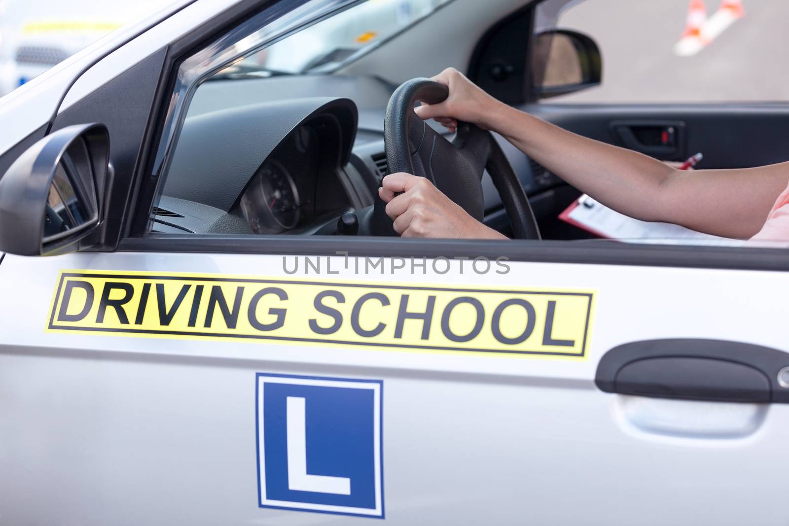 Learning to drive a car. Driving school. by wellphoto