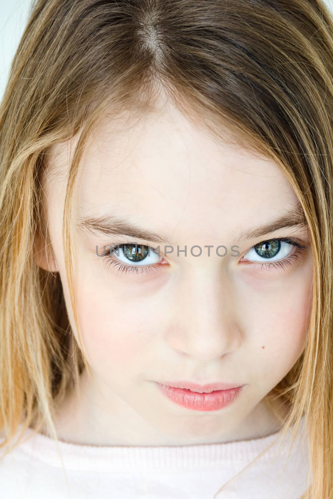 Cute girl eleven years old with blond long hair and green eyes