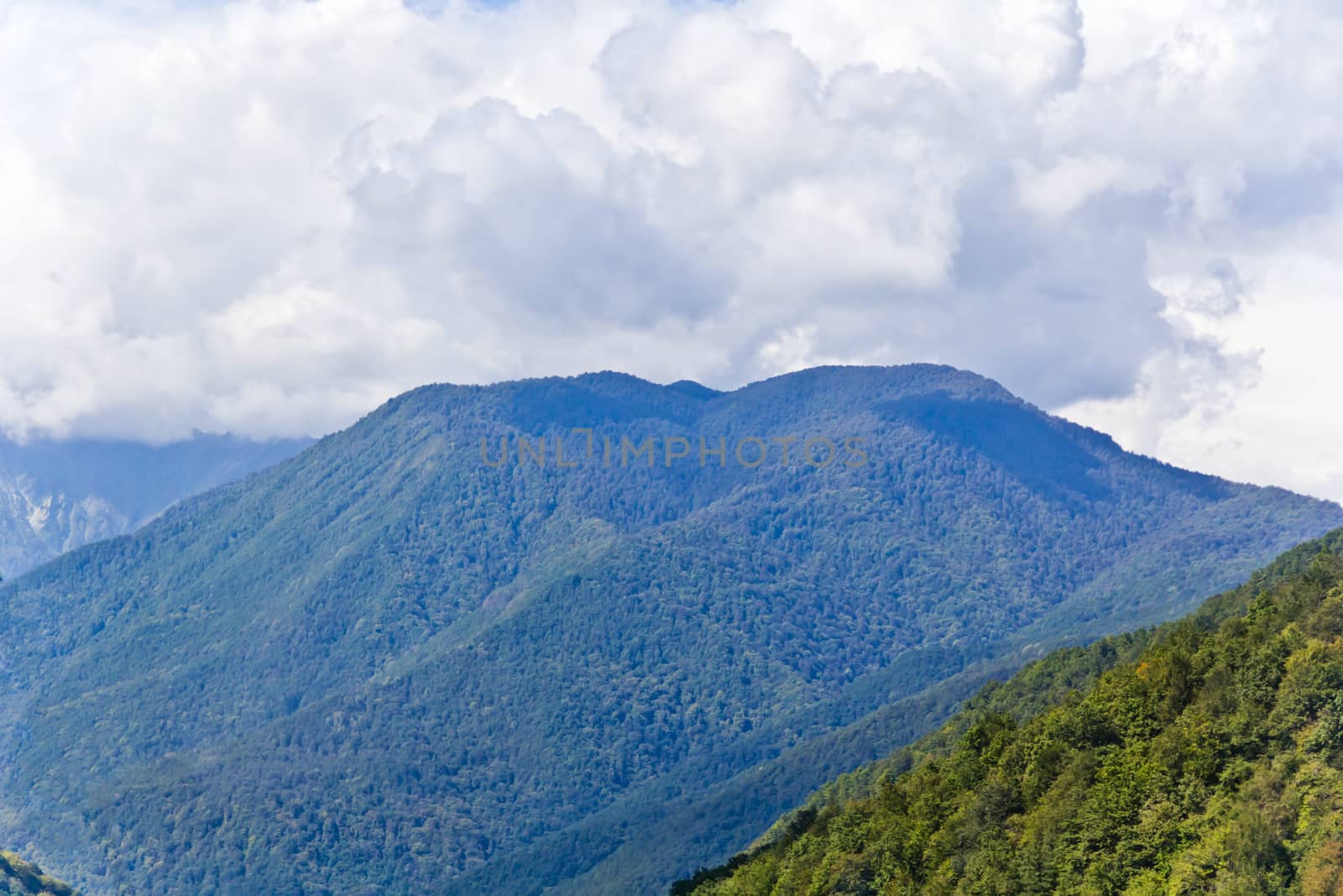 Summer landscape with Russian Caucasus rockies mountains with grey sky