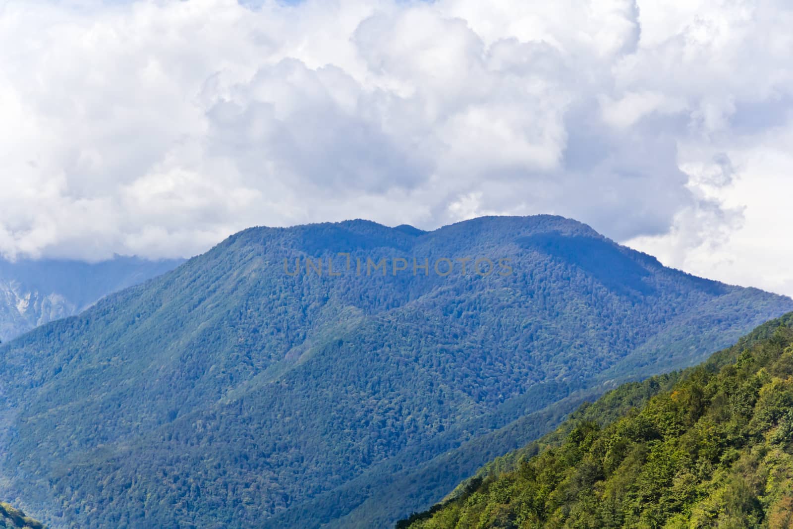 Summer landscape with Russian Caucasus rockies mountains with grey sky