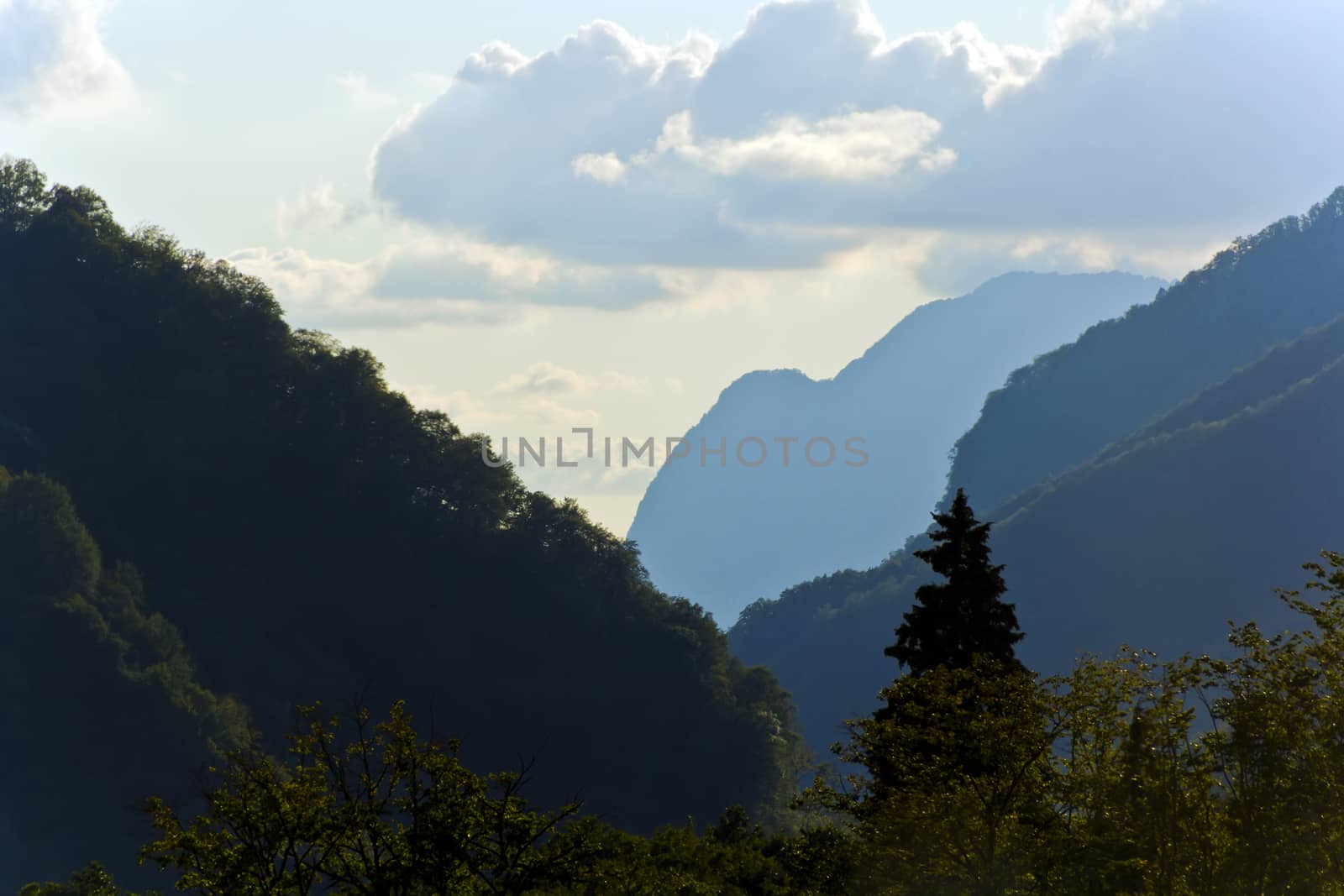 Summer picturesque landscape with Russian Caucasus rockies mountains with blue sky