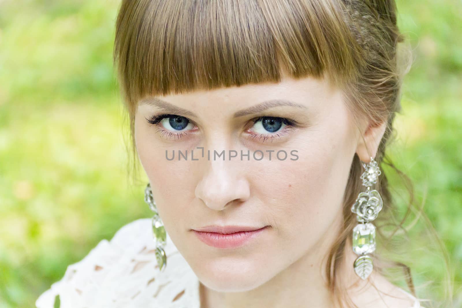 Beautiful bride with diadem on green background