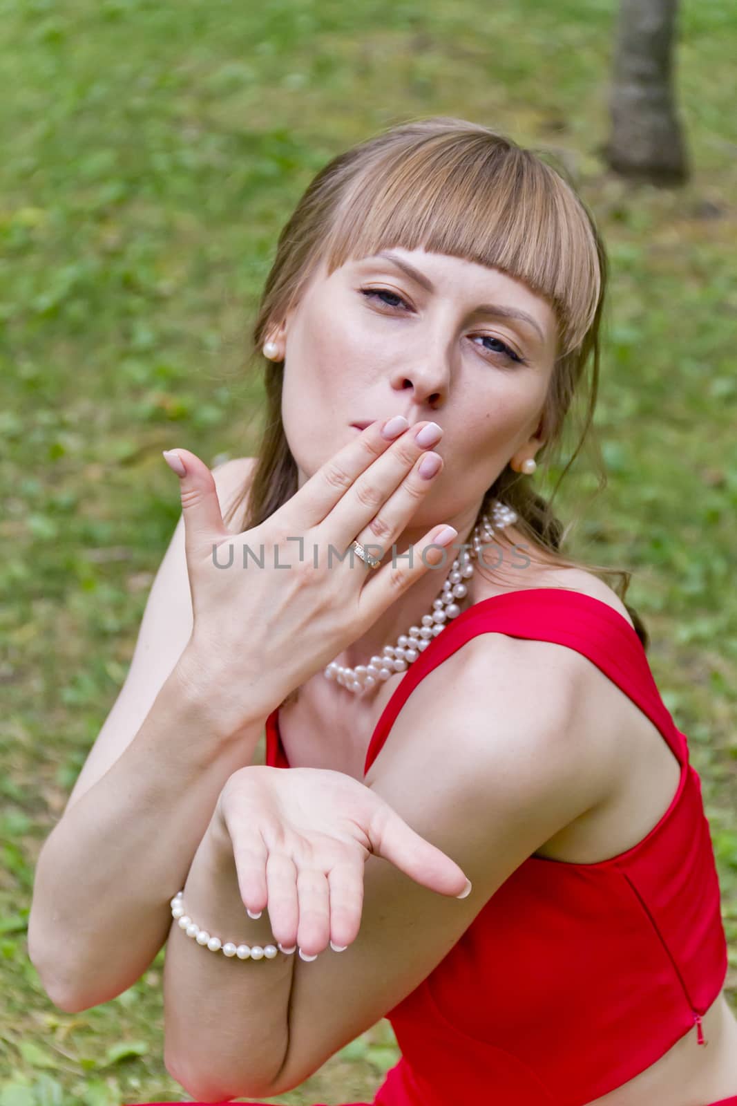 Portrait of beautiful girl in red are sending air kiss