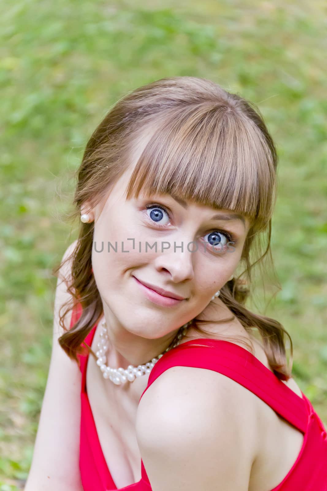 Beautiful girl in red with bulging eyes