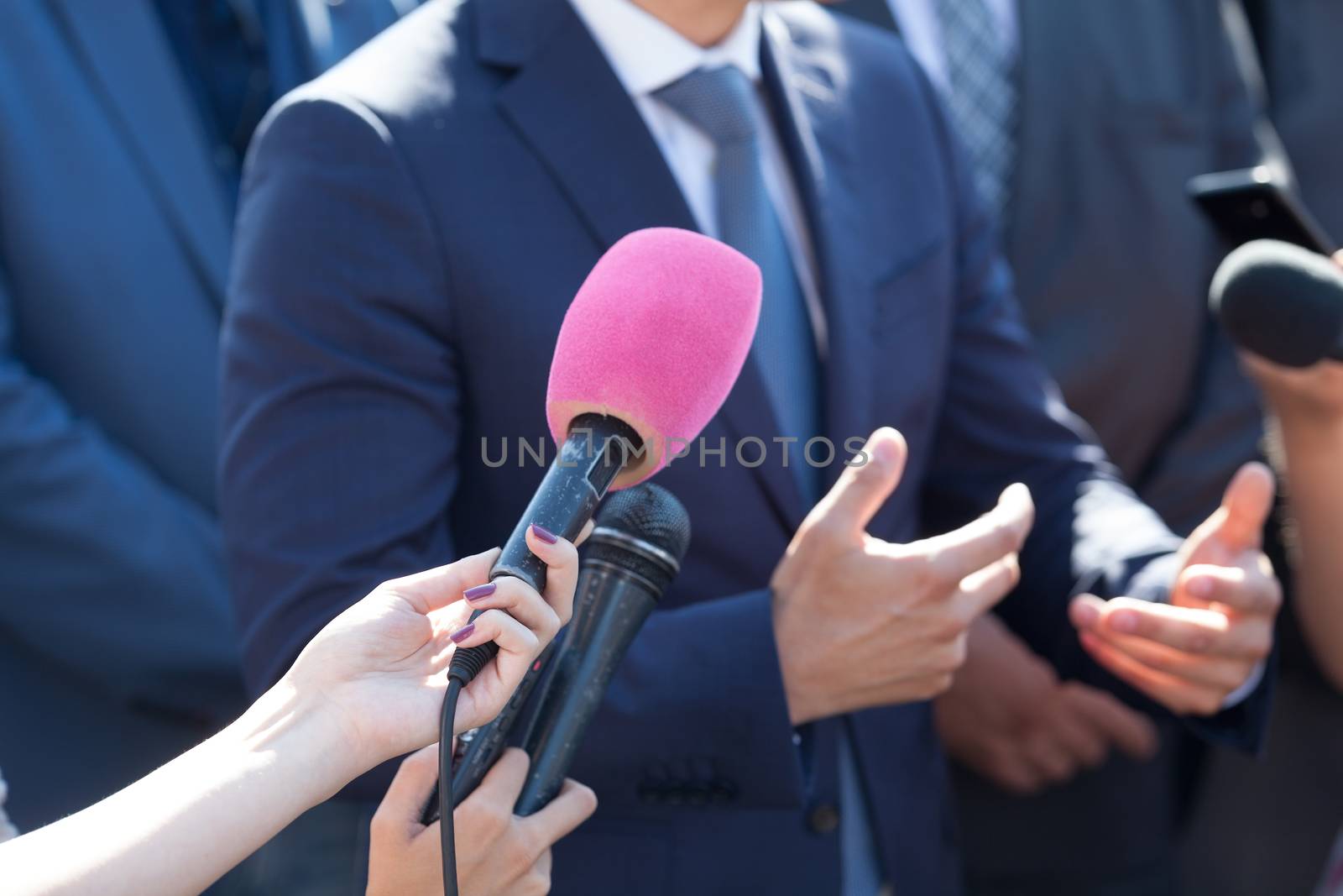 Media interview. Hand gesture. Business person or politician. by wellphoto