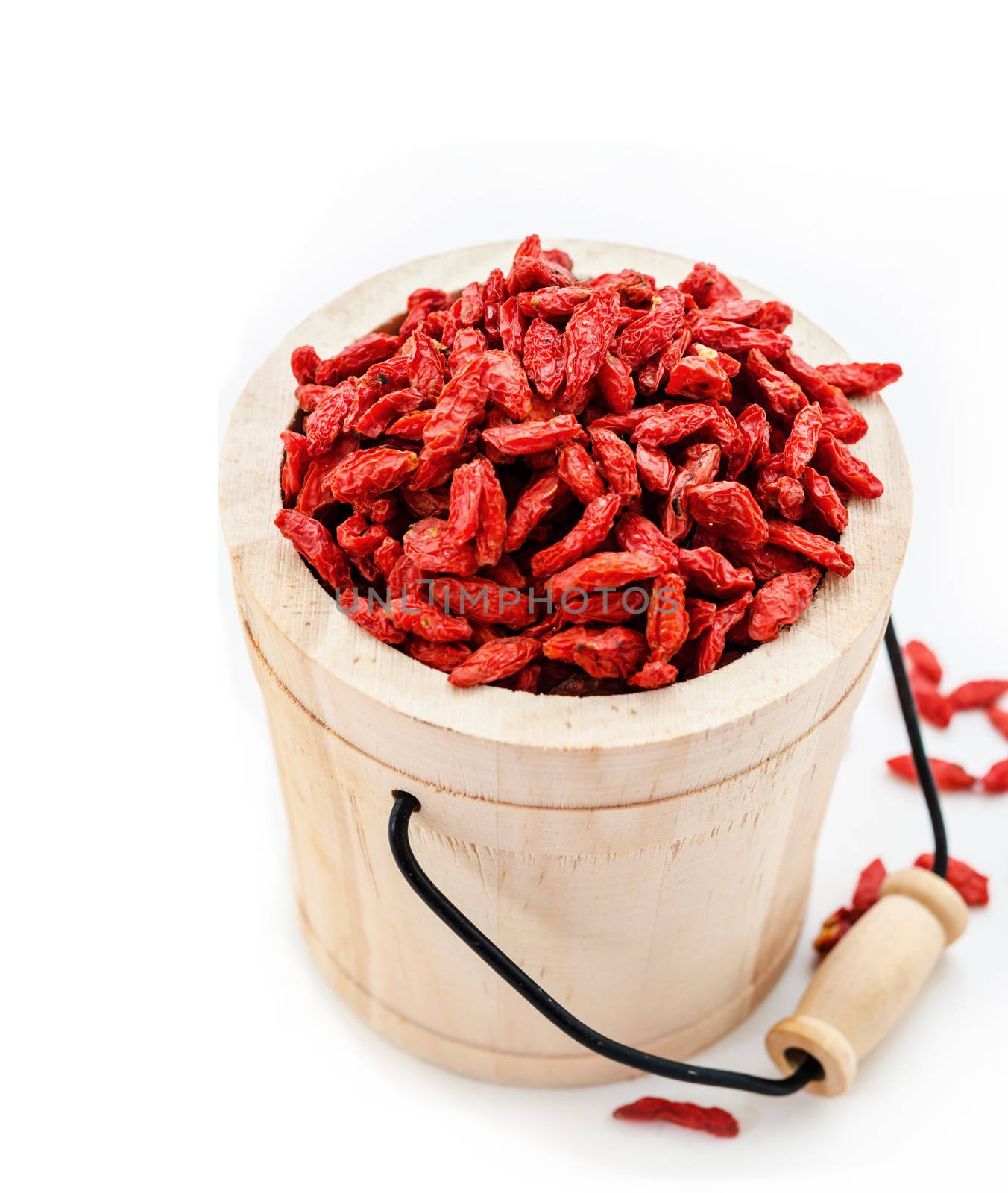 Red dried goji berries in wooden bucket. by Gamjai