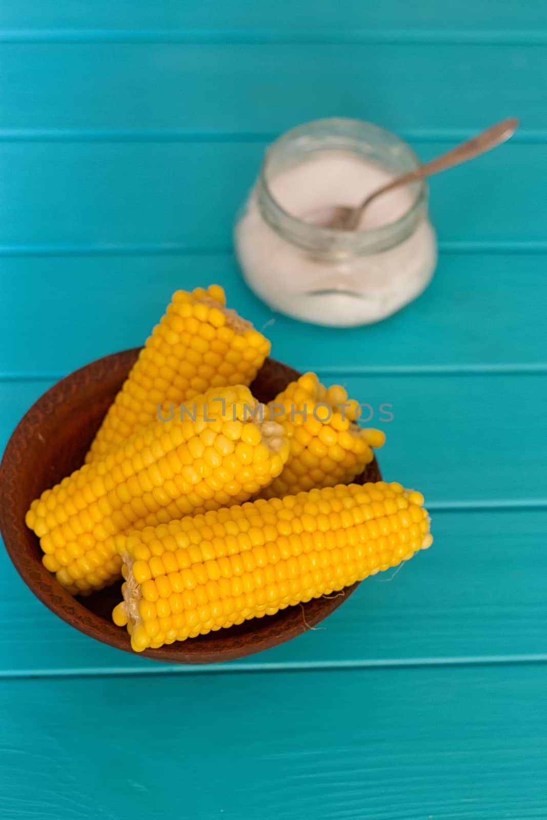 Boiled corn on a blue wood background