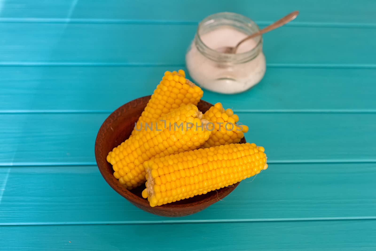 Boiled corn on a blue wood background