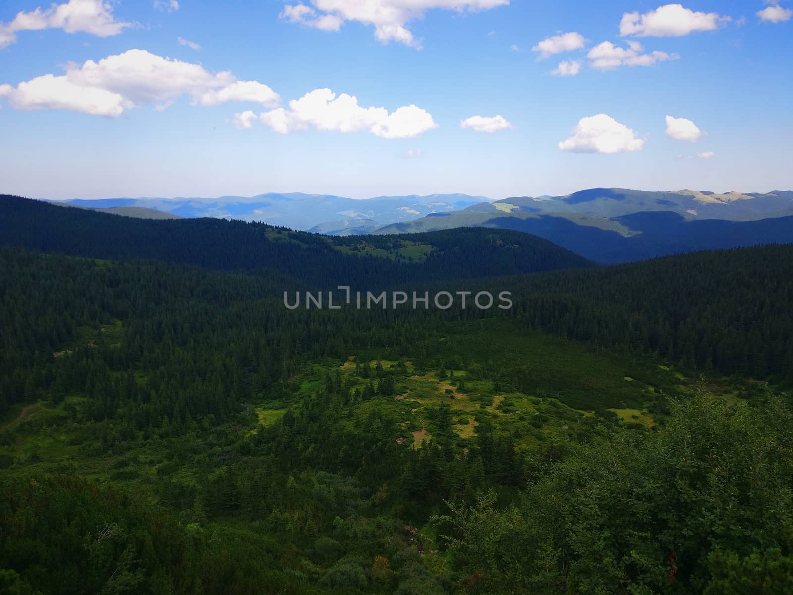 Peaceful green mountains covered of grass under the clear blue sky by natali_brill