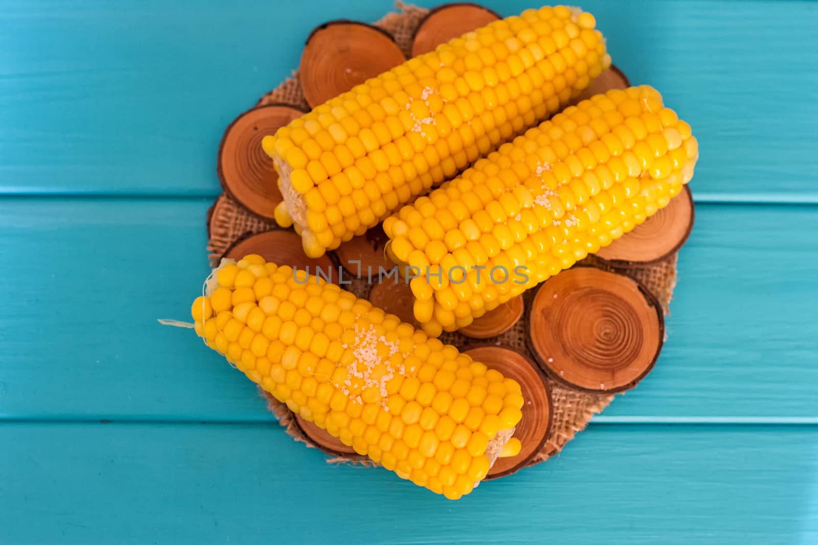 Boiled corn on a blue background by victosha