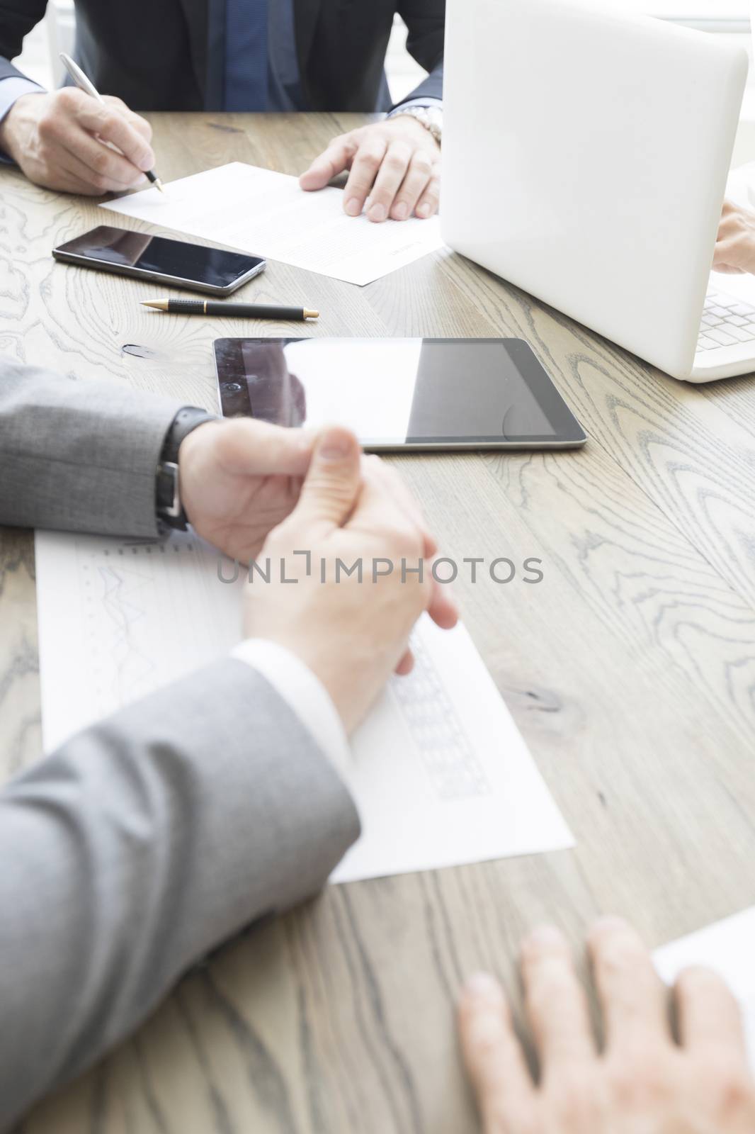 Business people work with documents and computers at office table close up
