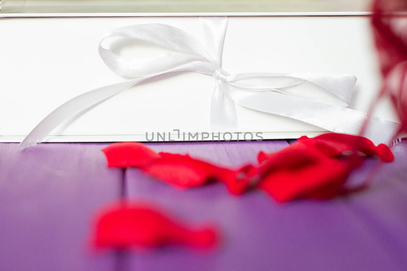 Rose petals and gift box with ribbon