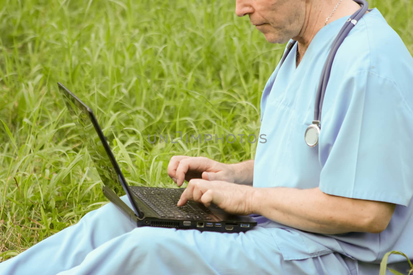 Doctor and nature concept. The doctor is holding a notebook in his hand. MEDICINE AND TECHNOLOGY. Photo horizontal for your design.