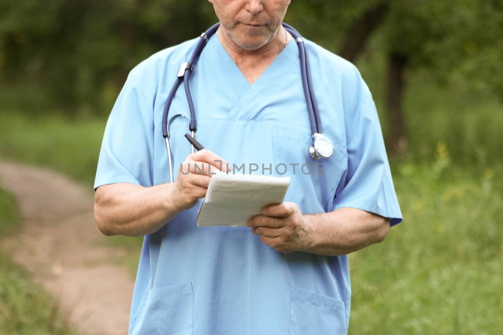 Doctor and nature concept. THE DOCTOR KEEPS MARKER IN THE HAND OVER THE LOCK. Photo horizontal for your design.