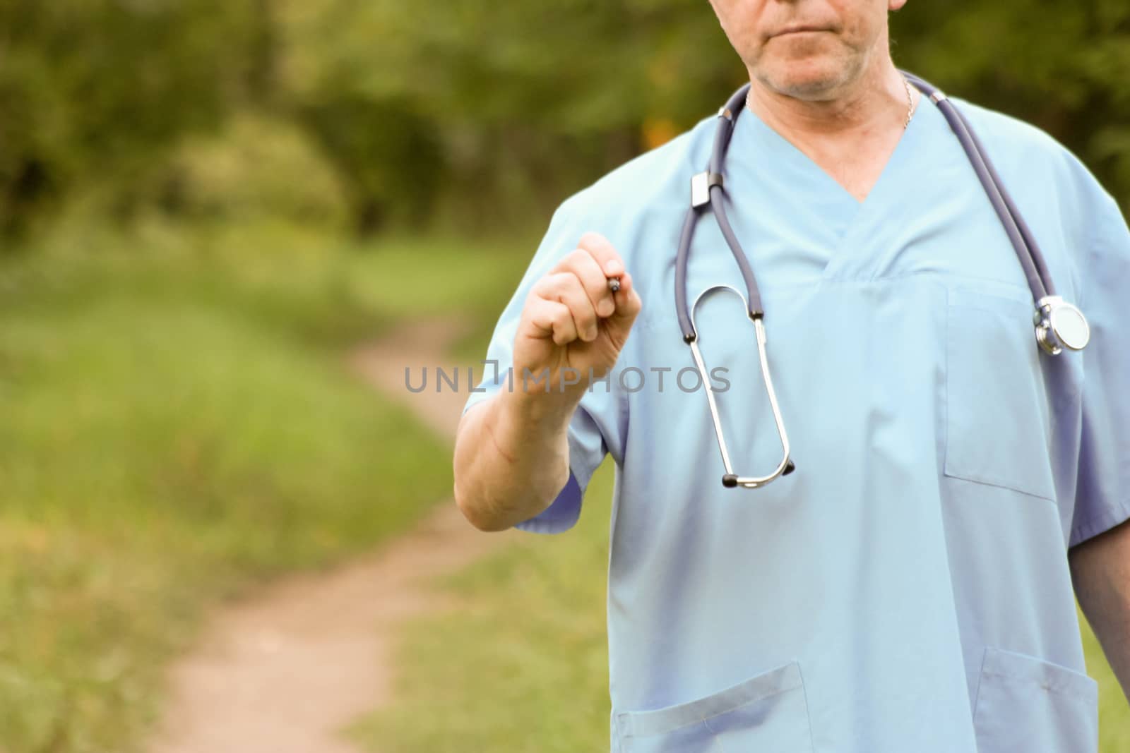 Doctor and nature concept. THE DOCTOR KEEPS MARKER IN THE HAND. Photo horizontal for your design.