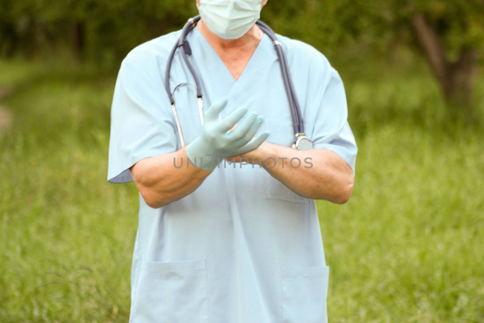 Doctor concept treatment nature. The doctor wears medical blue gloves. Photo horizontal for your design.