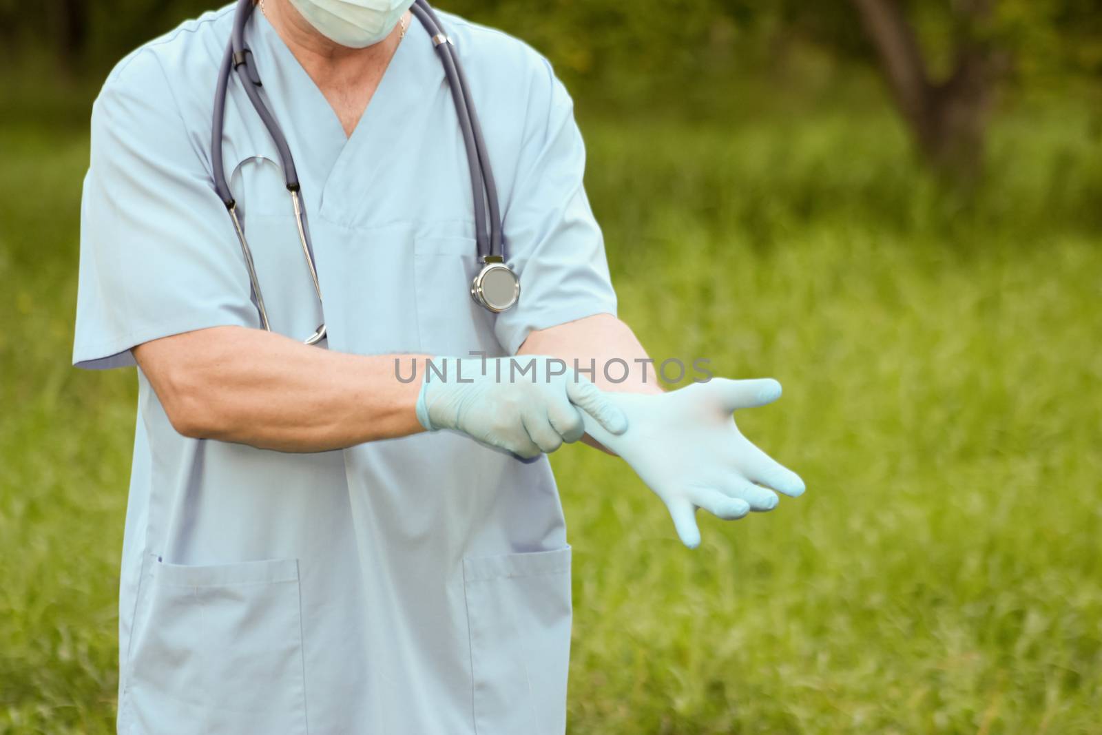 Doctor concept treatment nature. The doctor wears a glove on his arm. Photo horizontal for your design.