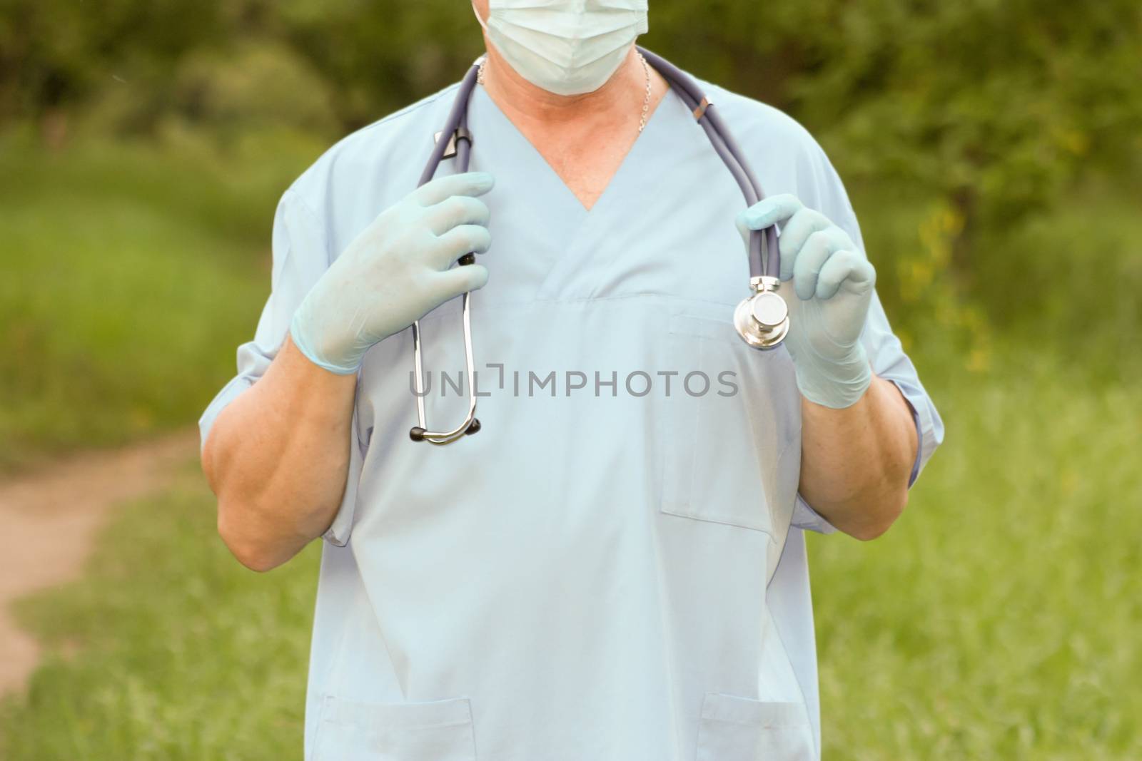 Doctor concept treatment nature. The doctor is holding a stethoscope in his hands. Photo horizontal for your design.