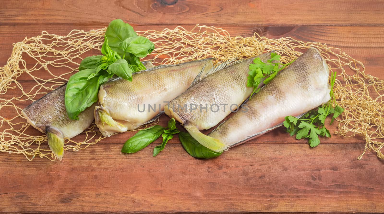 Several carcasses of the notothenia fish on a wooden surface by anmbph