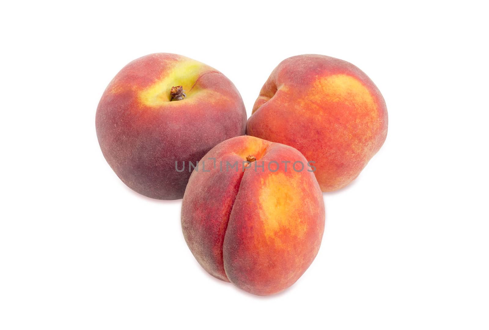 Three ripe fresh peaches on a white background
