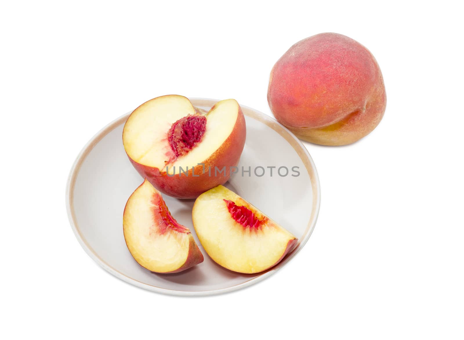 Whole peach and sliced peach on a saucer by anmbph